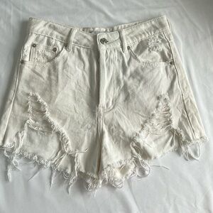 White Adika denim shorts with rips.